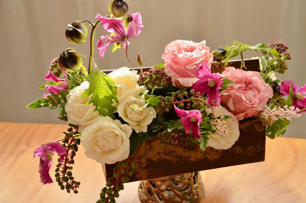 Beginner floristry course, flower box design with roses, clematis and phytolacca