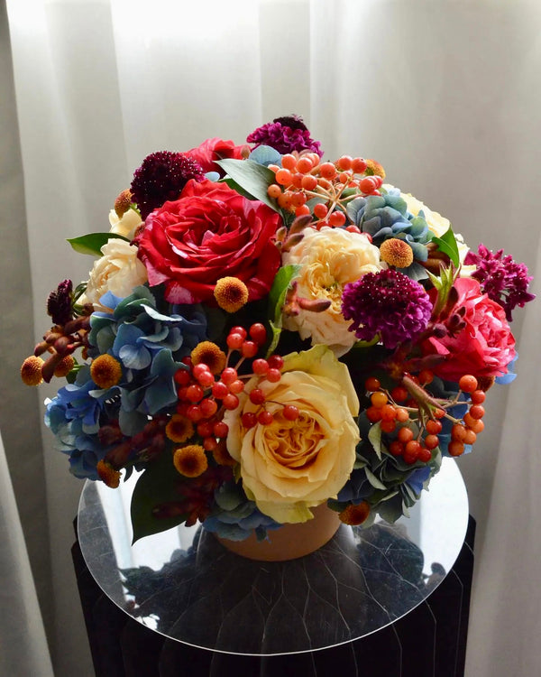 Beginner floristry course, round design with hydrangeas, roses, viburnum berries, scabiosa and spray chrysanthemums