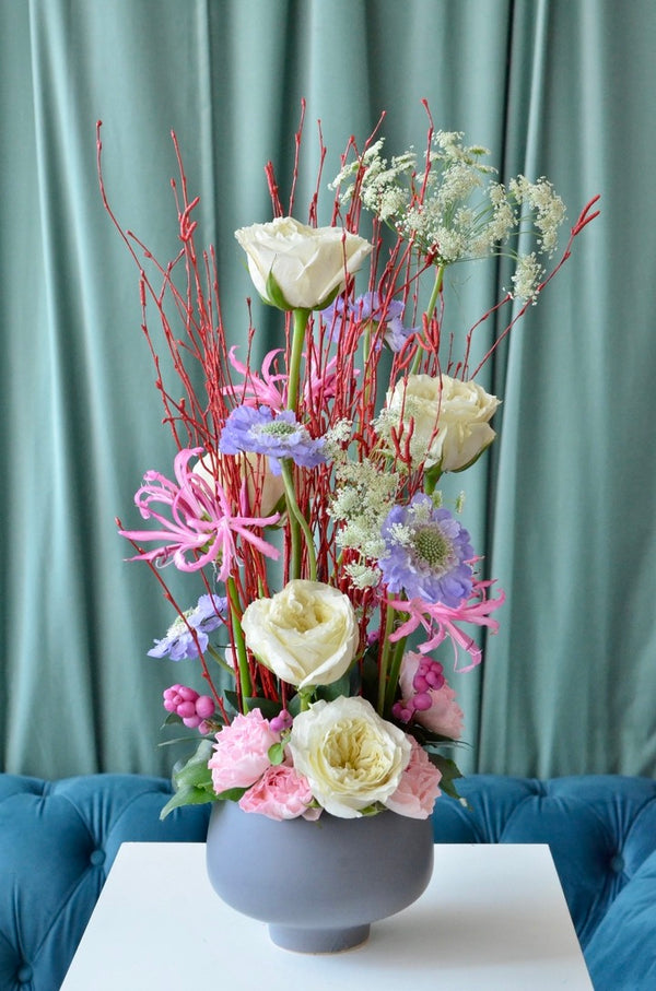 Beginner floristry course, vertical design with birch twigs, roses, scabiosa, nerine, symphoricarpos and ammi majus