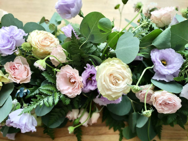 Intermediate floristry course, low table centrepiece with roses, lisianthus, scabiosa, didiscus and oxypetalum