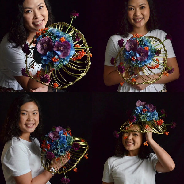 Intermediate floristry course, student holding a collar bouquet with hydrangeas, vanda, viburnum berries and scabiosa, featuring bear grass braiding technique