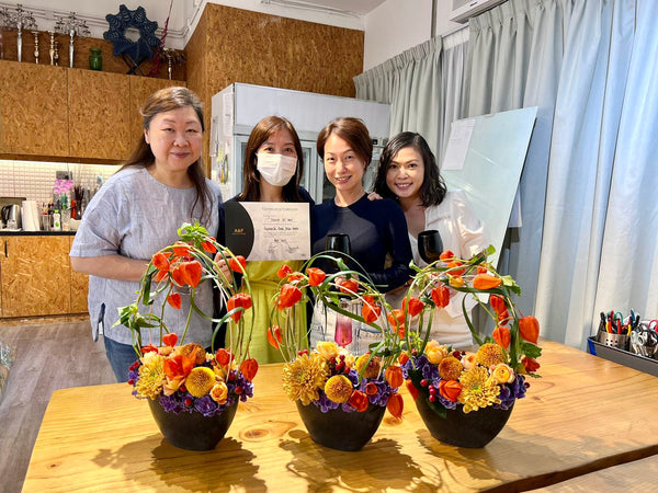 Intermediate floristry course, framing design flower arrangement with hydrangeas, chrysanthemums, spray roses, hypericum and physalis
