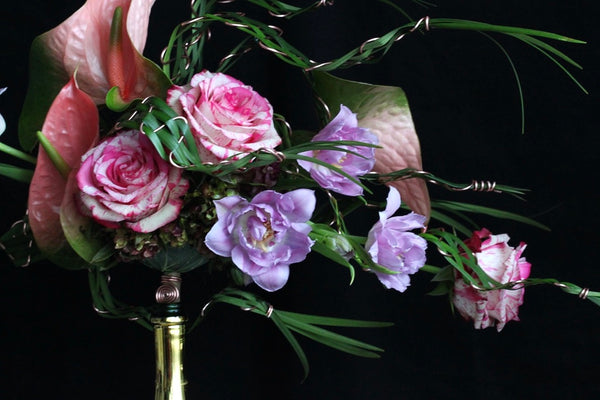 Intermediate floristry course, bouquet in bouquet holder with anthuriums, roses and tulips, featuring leaf manipulation technique
