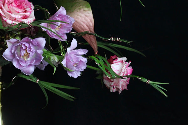 Intermediate floristry course, bouquet in bouquet holder with anthuriums, roses and tulips, featuring leaf manipulation technique
