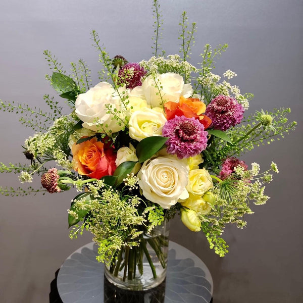 Intermediate floristry course, hand tied bouquet with roses, lisianthus, scabiosa, ammi majus and thlaspi
