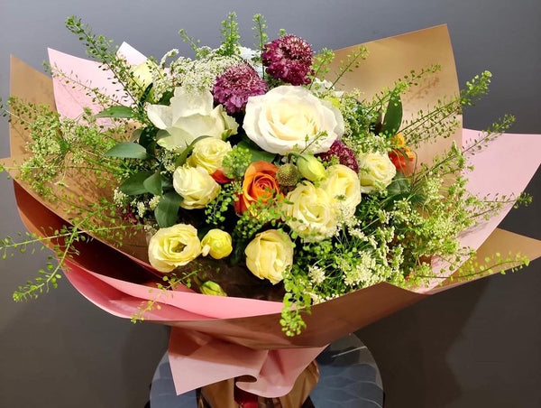 Intermediate floristry course, hand tied bouquet with roses, lisianthus, scabiosa, ammi majus and thlaspi