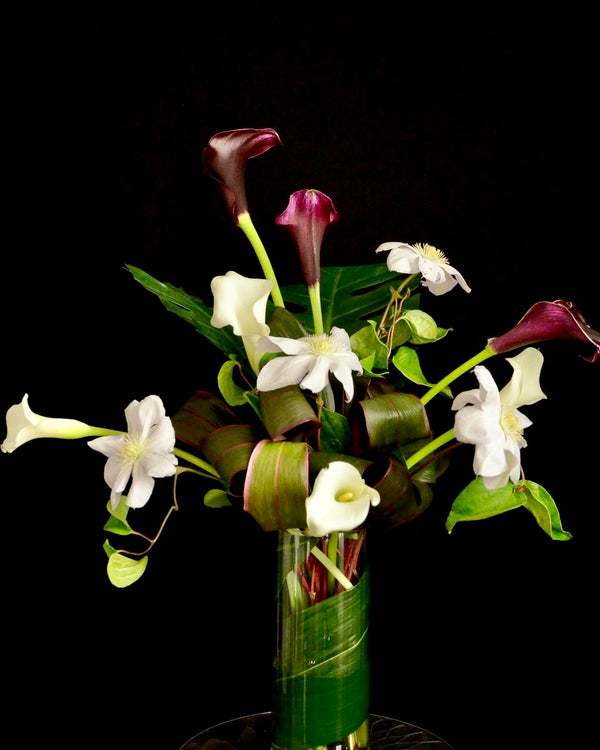 Intermediate floristry course, vase arrangement with clematis and calla lilies, featuring leaf manipulation technique