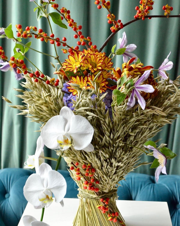 Intermediate floristry course, vase arrangement with dried oat, celastrus, hydrangeas, chrysanthemums, helenium, clematis and phalaenopsis orchids