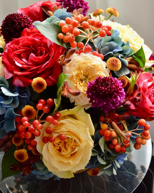 Beginner floristry course, round design with hydrangeas, roses, viburnum berries, scabiosa and spray chrysanthemums
