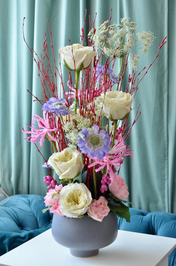 Beginner floristry course, vertical design with birch twigs, roses, scabiosa, nerine, symphoricarpos and ammi majus