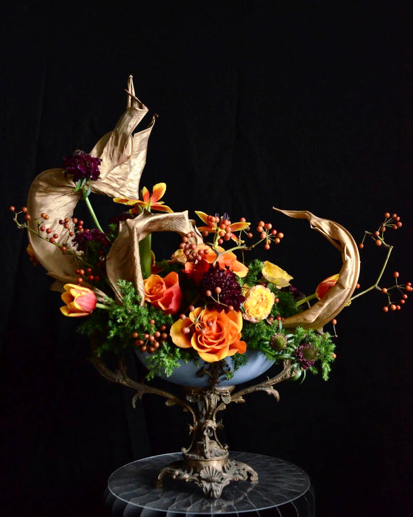 Floristry class. Student's work. Arrangement with dried Strelitzia leaves.