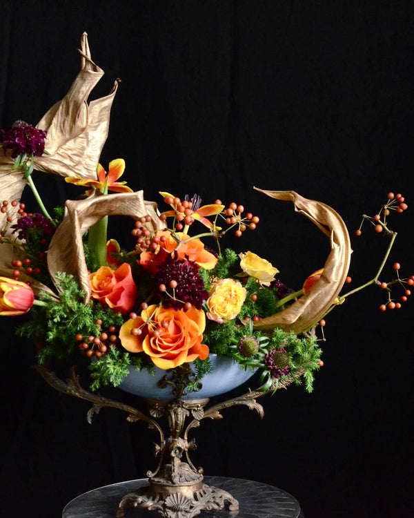 Floristry class. Student's work. Arrangement with dried Strelitzia leaves.