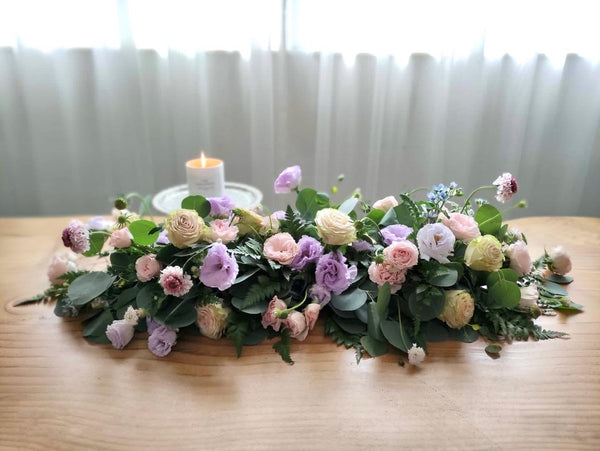 Intermediate floristry course, low table centrepiece with roses, lisianthus, scabiosa, didiscus and oxypetalum