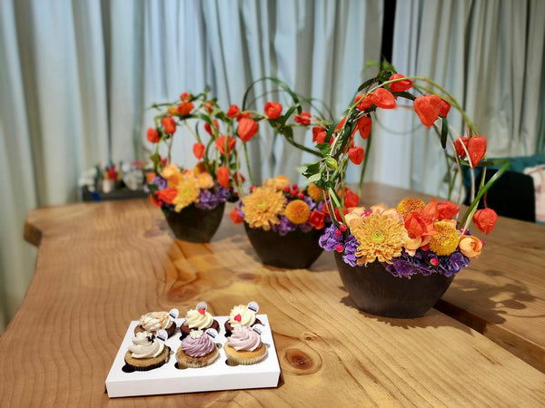 Intermediate floristry course, framing design flower arrangement with hydrangeas, chrysanthemums, spray roses, hypericum and physalis