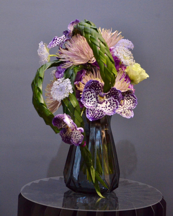Intermediate floristry course, hand tied bouquet with hydrangeas, chrysanthemums, vanda, lisianthus and didiscus, featuring bear grass braiding technique