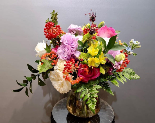 Intermediate floristry course, hand tied bouquet with roses, lisianthus, alstroemeria, viburnum berries, oxypetalum and asters