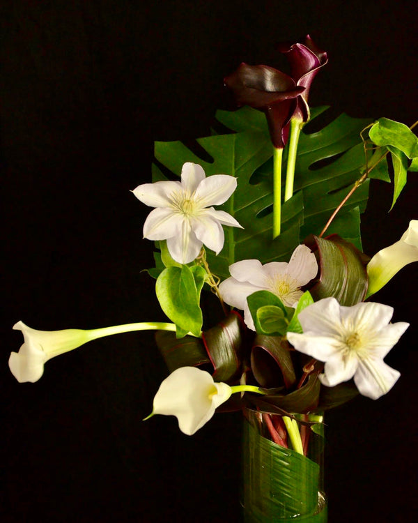 Intermediate floristry course, vase arrangement with clematis and calla lilies, featuring leaf manipulation technique