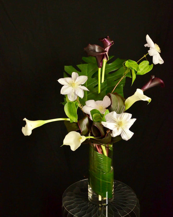 Intermediate floristry course, vase arrangement with clematis and calla lilies, featuring leaf manipulation technique