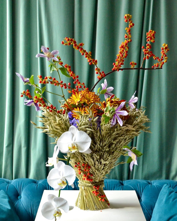 Intermediate floristry course, vase arrangement with dried oat, celastrus, hydrangeas, chrysanthemums, helenium, clematis and phalaenopsis orchids