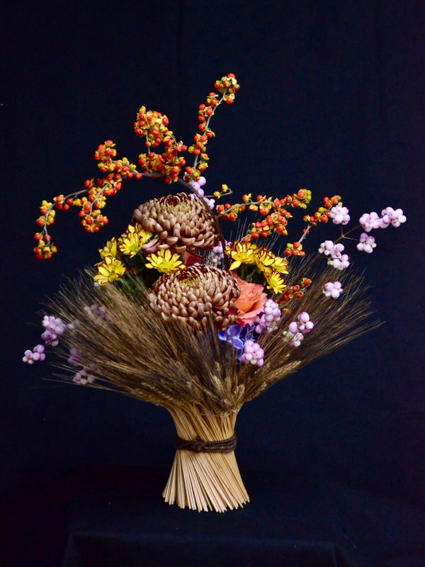 Vase arrangement with wheat sheaf.